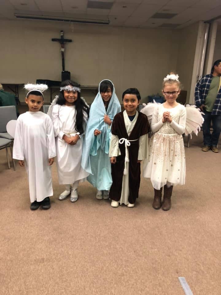 Five children in costumes, including angels and biblical figures