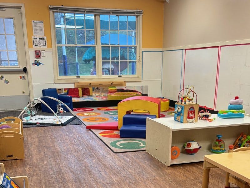 Colorful playroom with soft play items, educational toys, and playmat