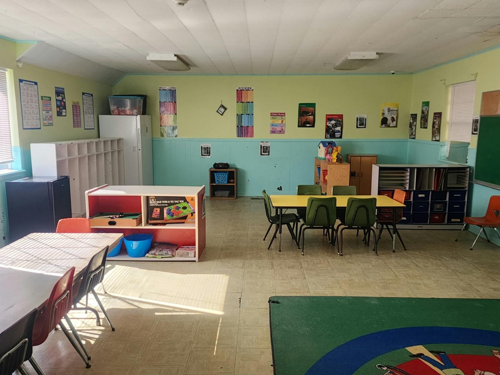 Classroom with tables, chairs, and shelves