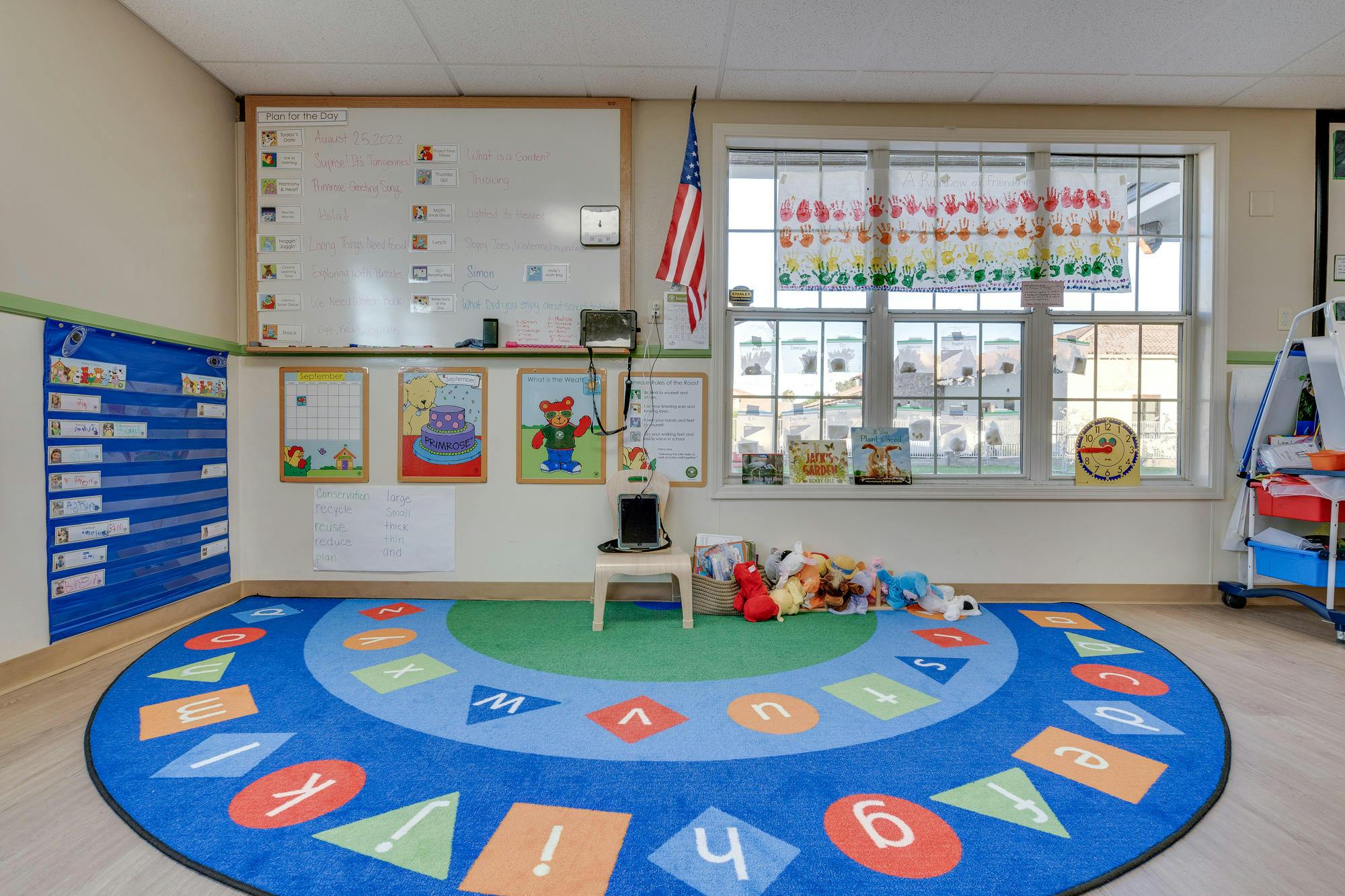 Classroom with a colorful rug, whiteboard, and window