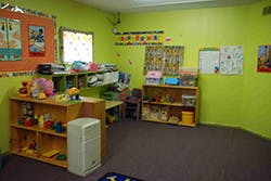 Classroom with shelves of toys and decorations on the wall