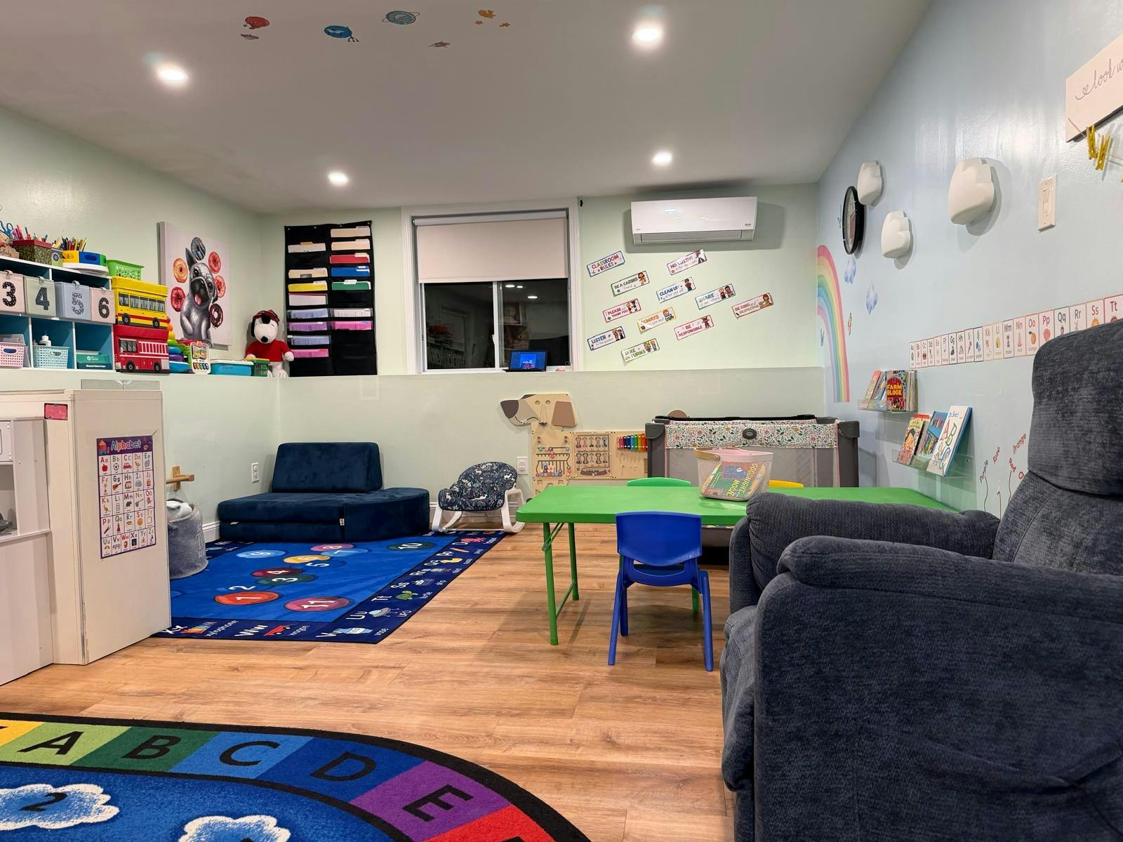 Classroom interior with educational toys, activity tables, and floor mats