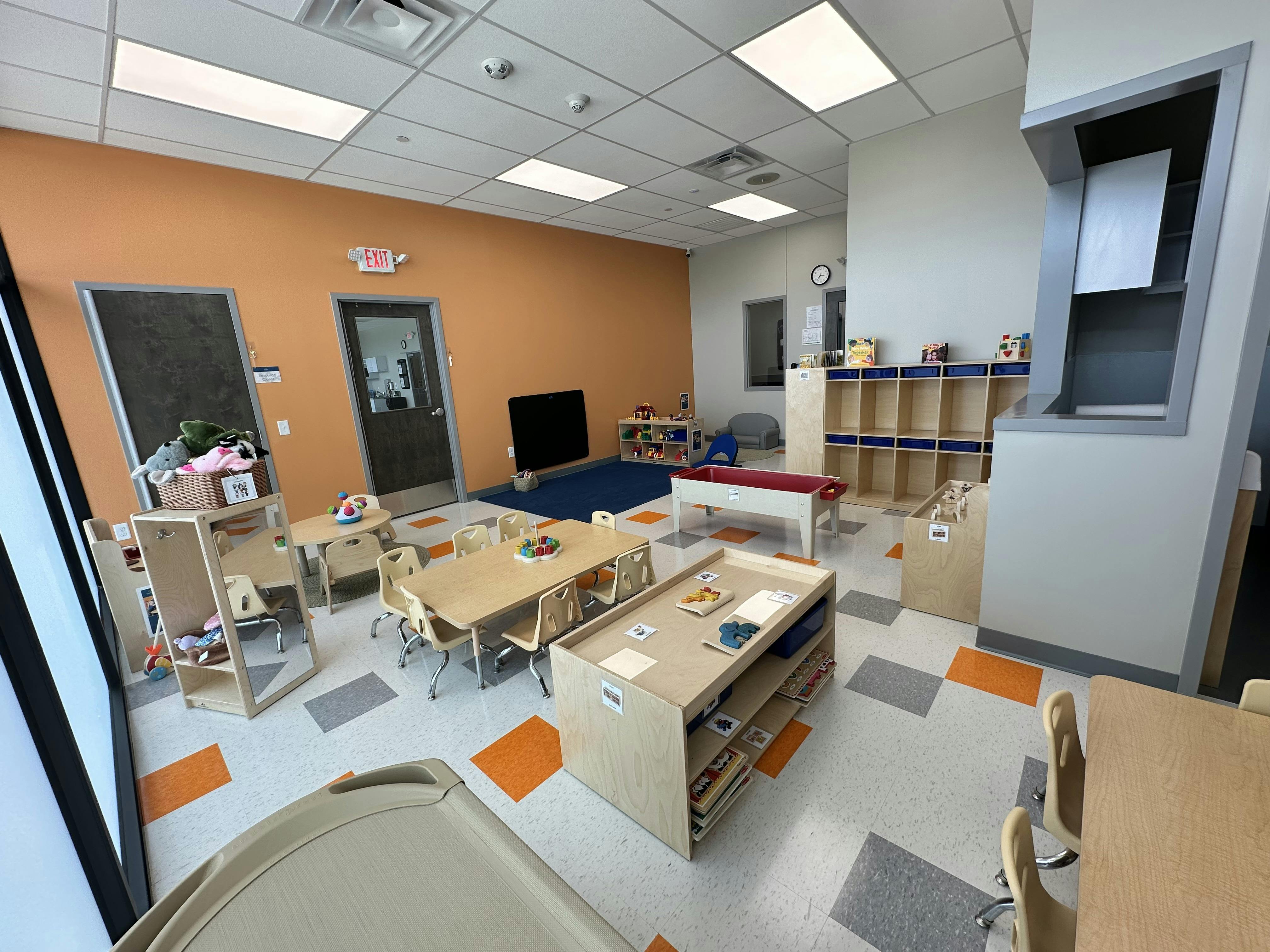 Empty classroom with small tables and chairs