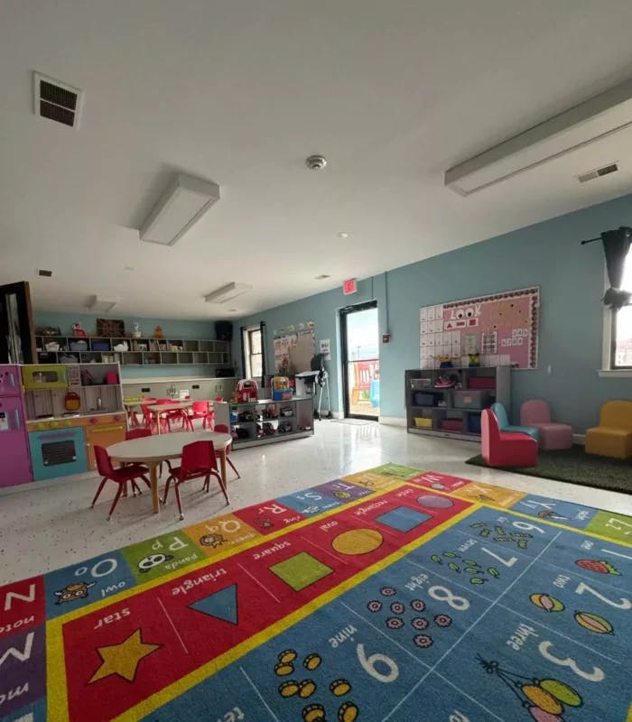 A colorful classroom with a large alphabet and numbers rug