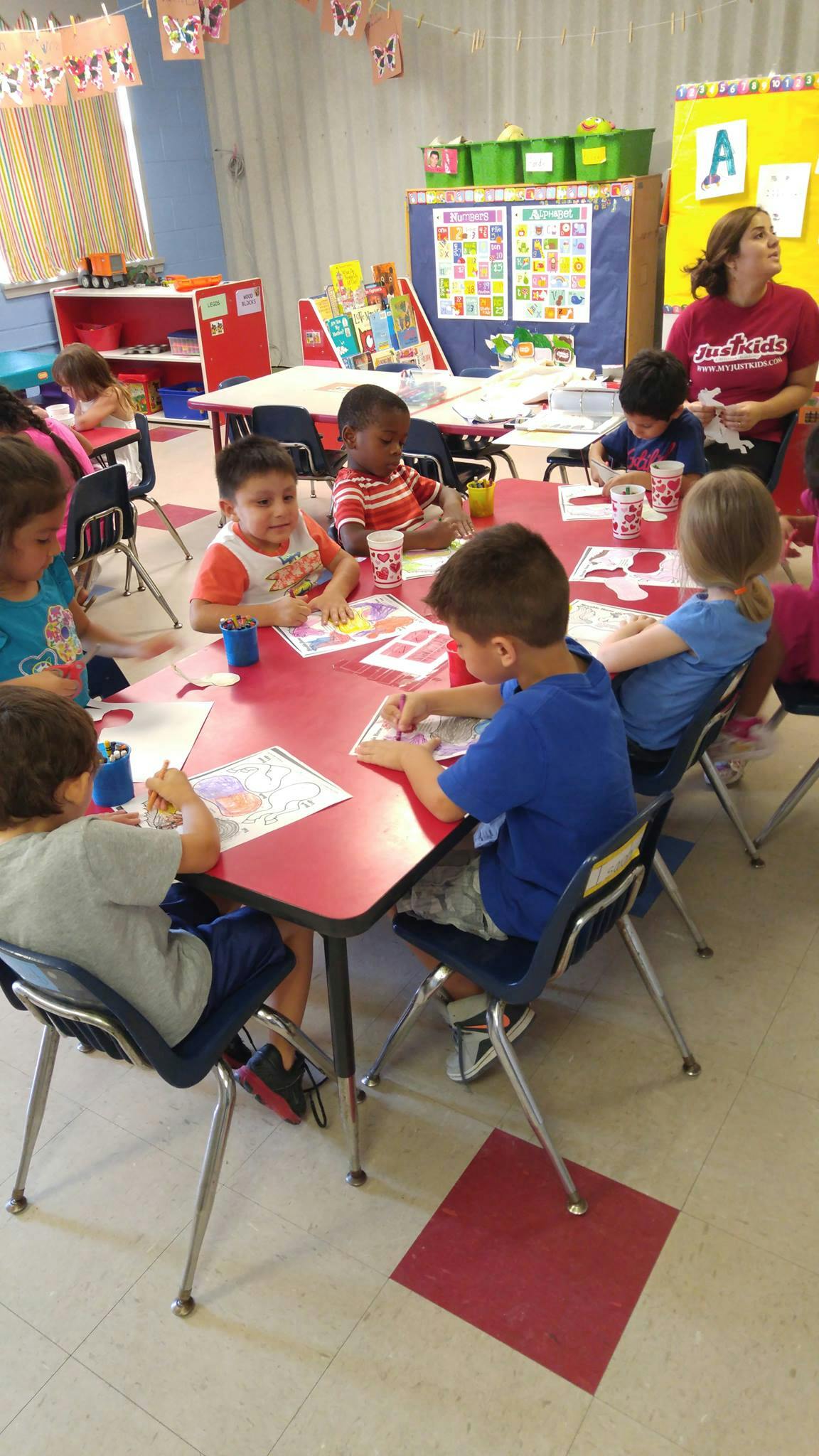 Children sitting at tables in a classroom