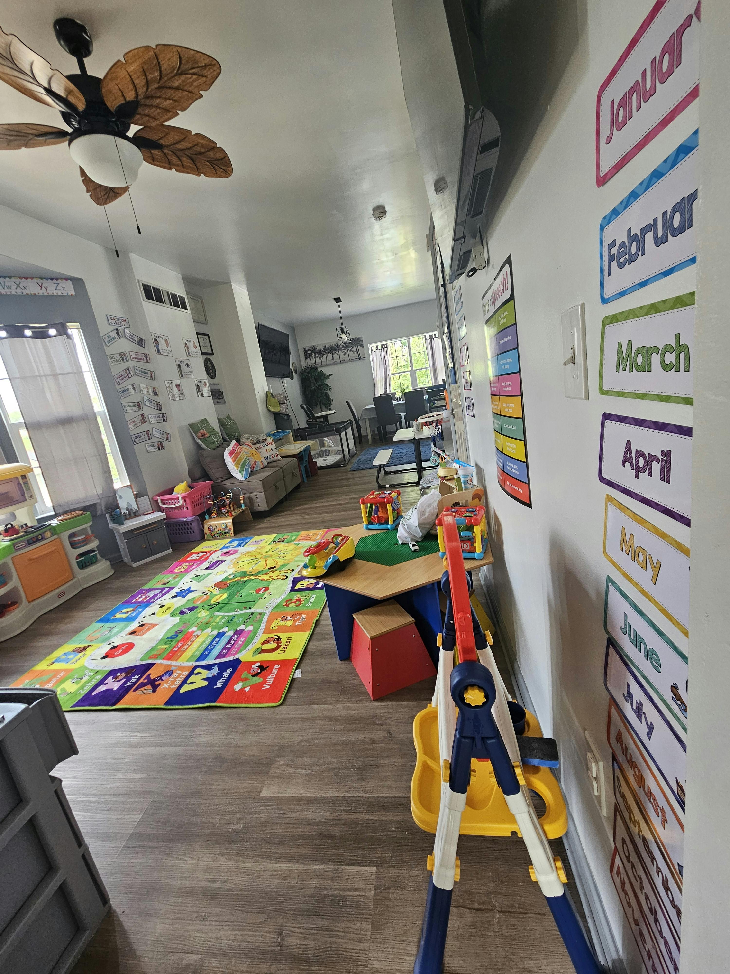Playroom with colorful alphabet rug and children's furniture