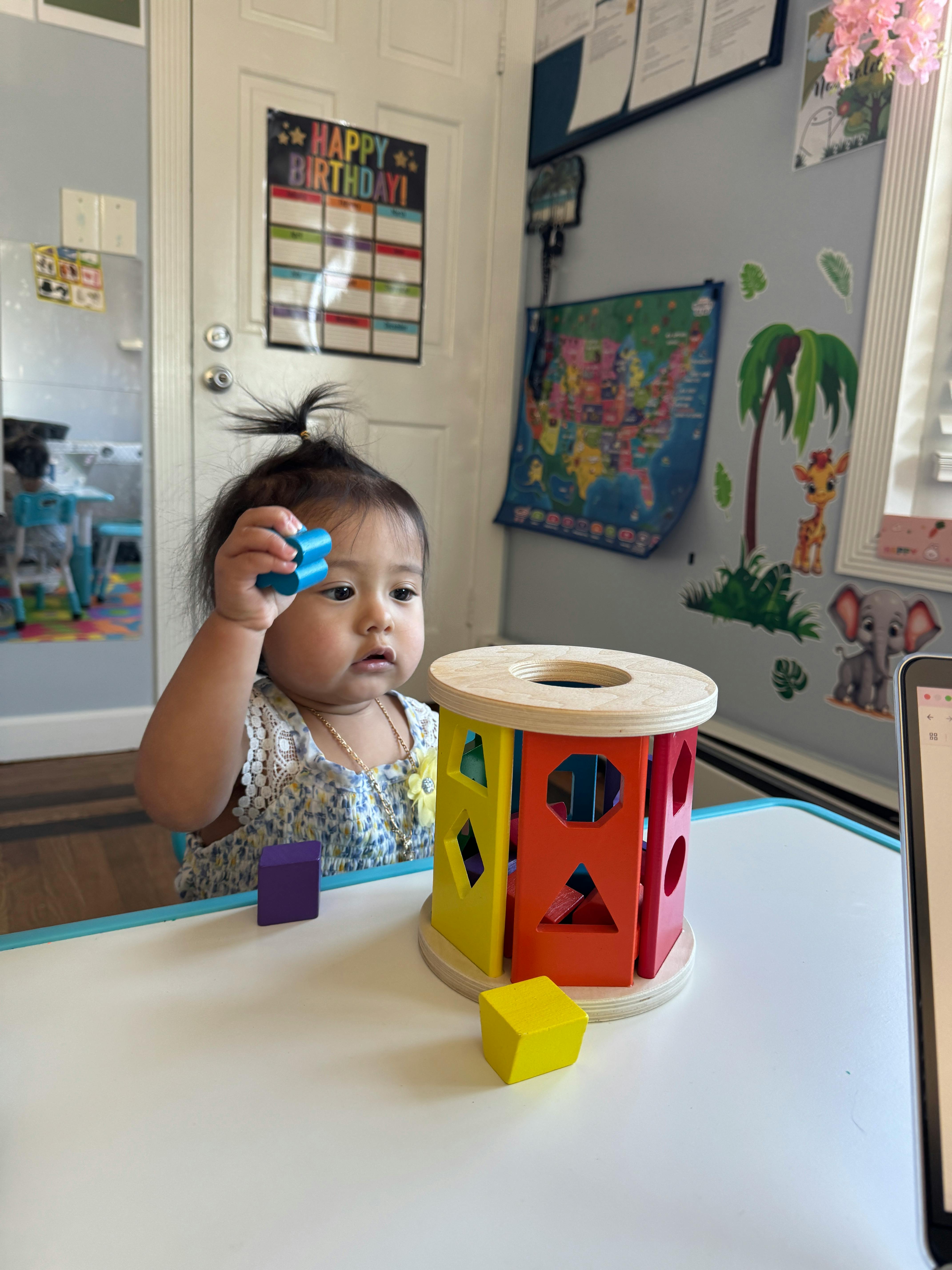 Child playing with a shape sorter toy