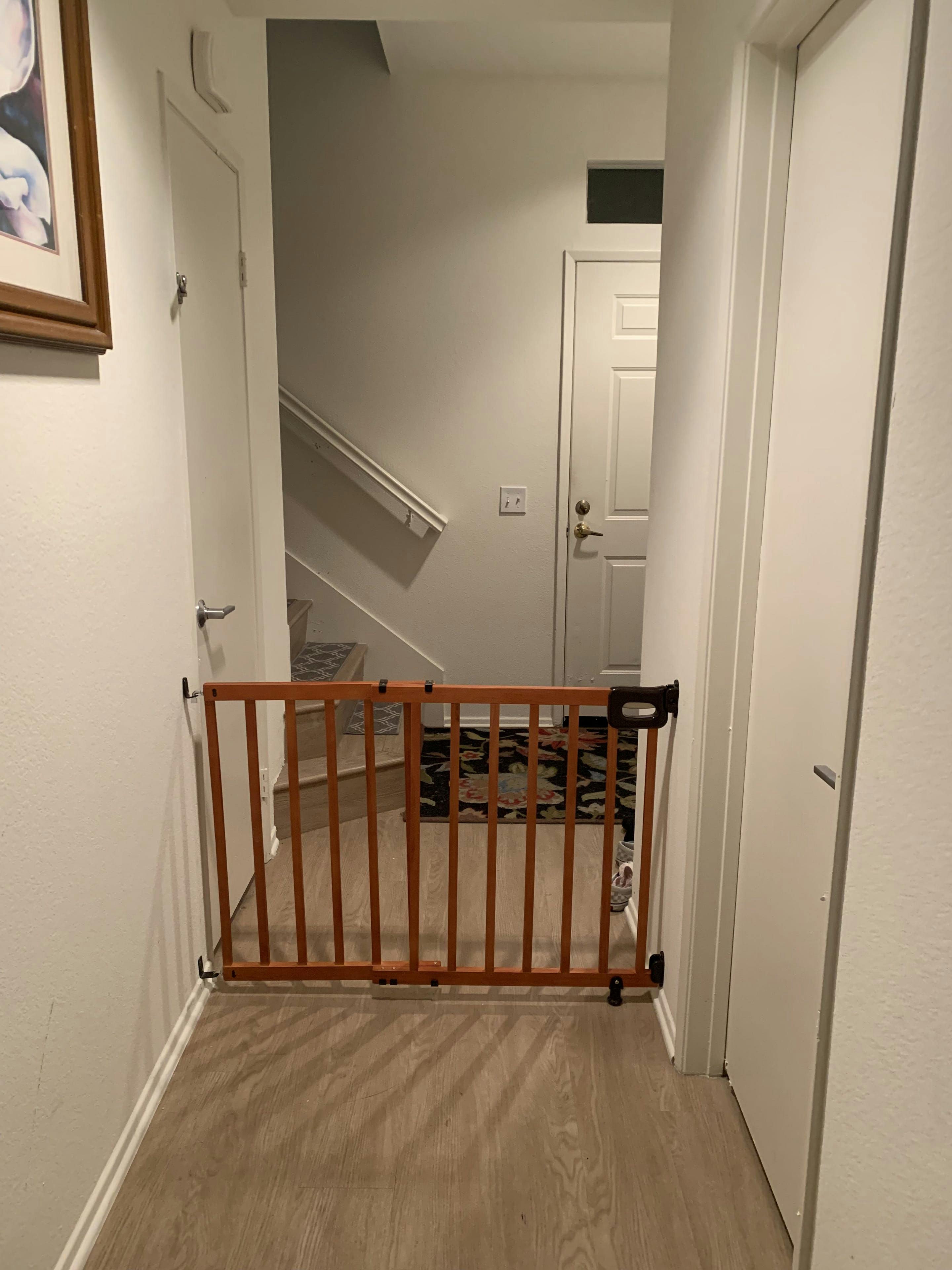 Wooden baby gate across a hallway