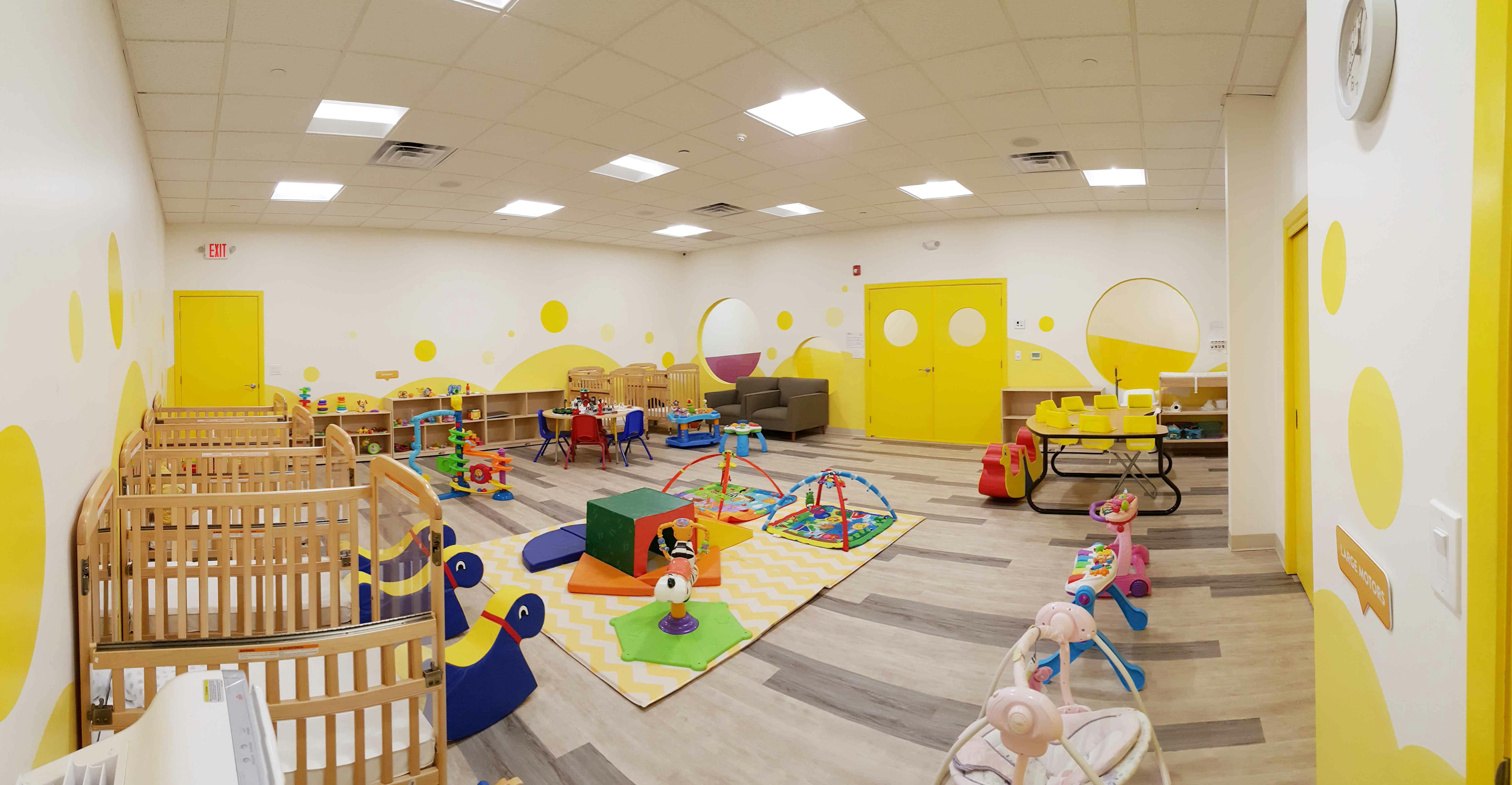Empty nursery room with cribs and play area