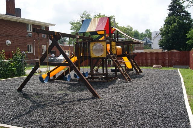 Playground with swings, slides, and climbing structure