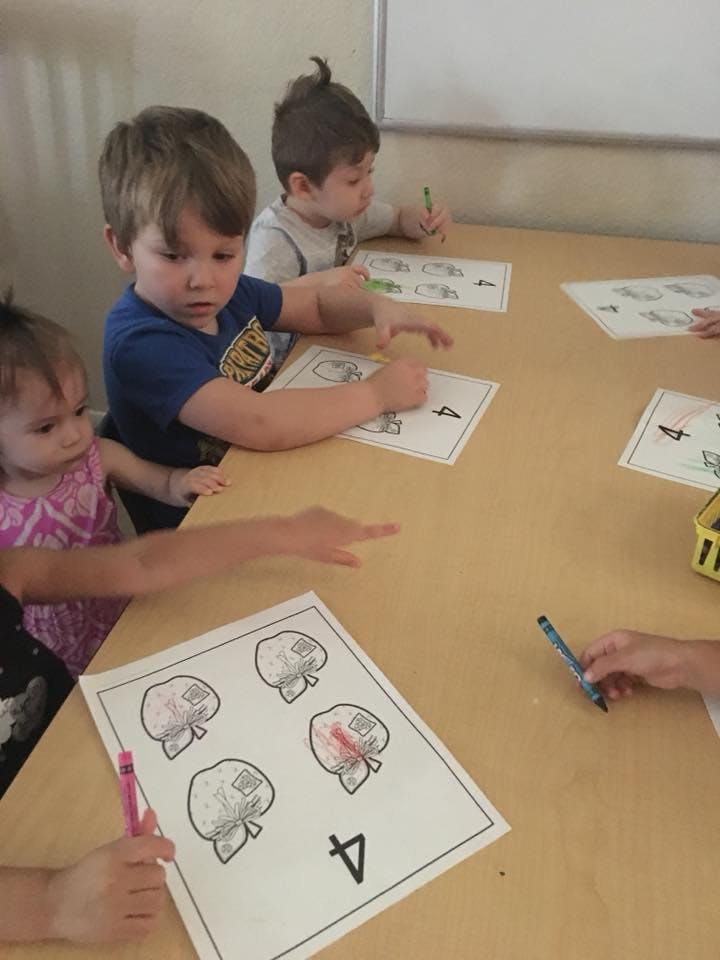 Children coloring at a table