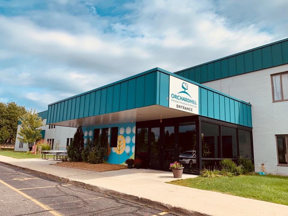Orchardhill building entrance with a teal awning