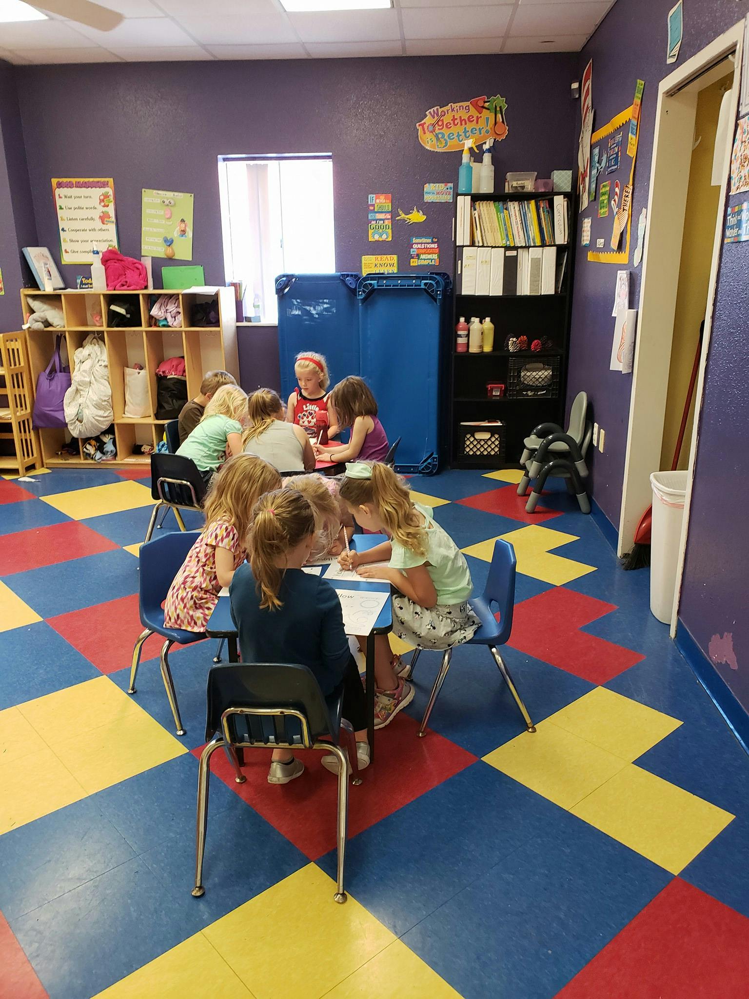 Children sitting at tables in a classroom