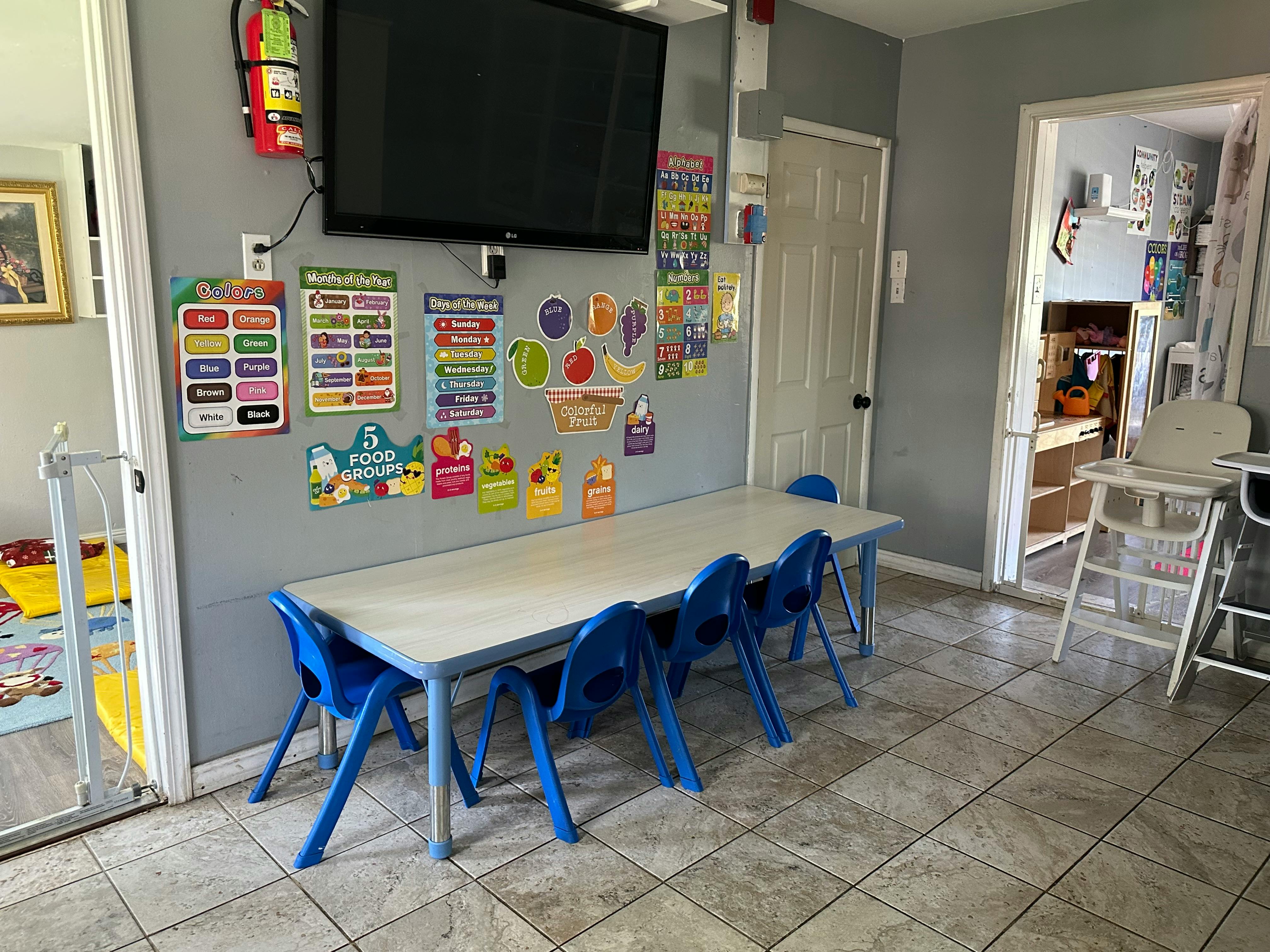 Long table with blue chairs in a classroom