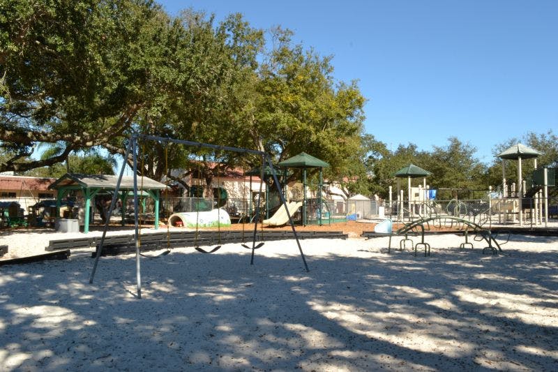 Empty playground with swings and climbing structures