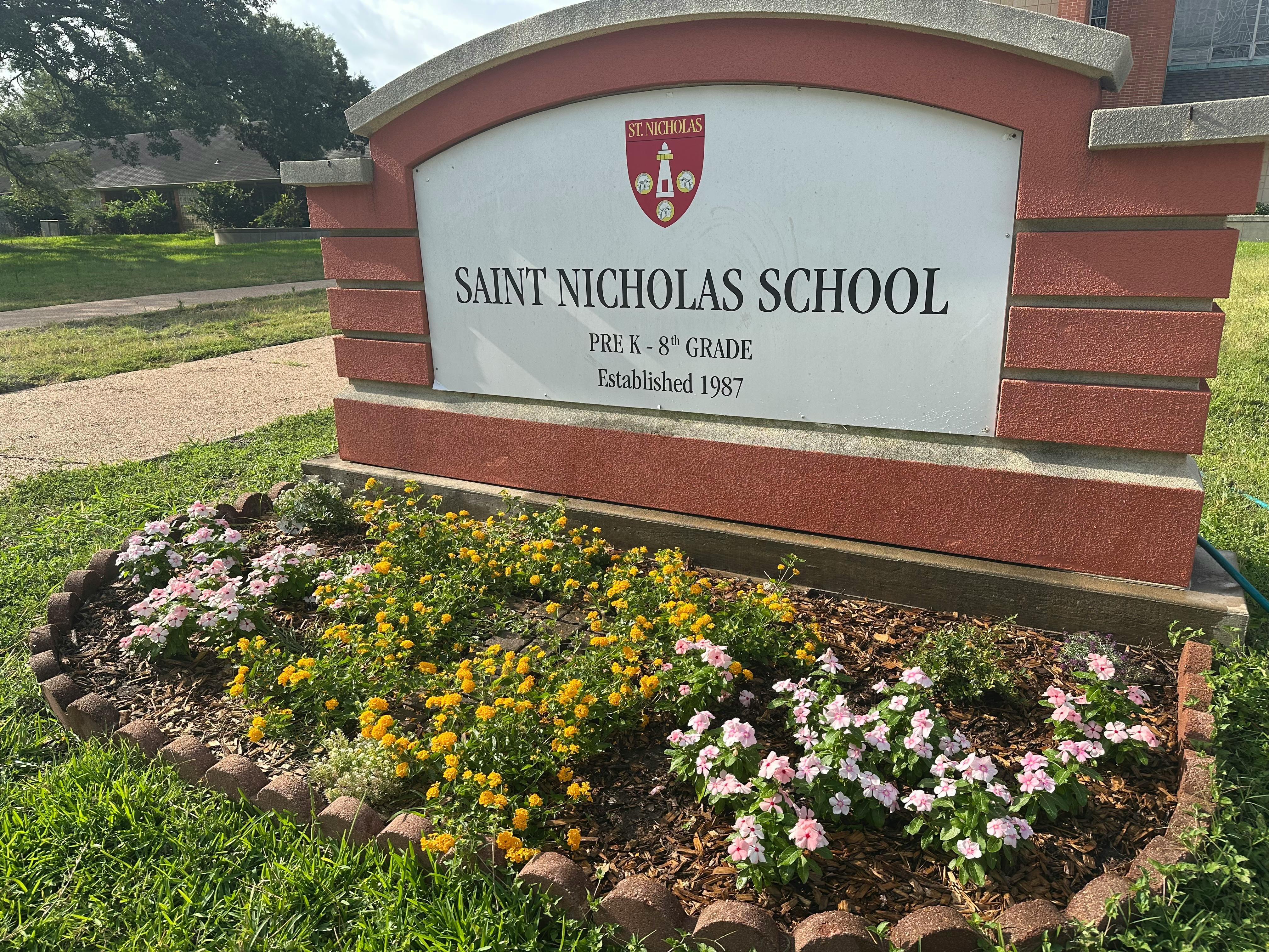 Saint Nicholas School sign with flowers