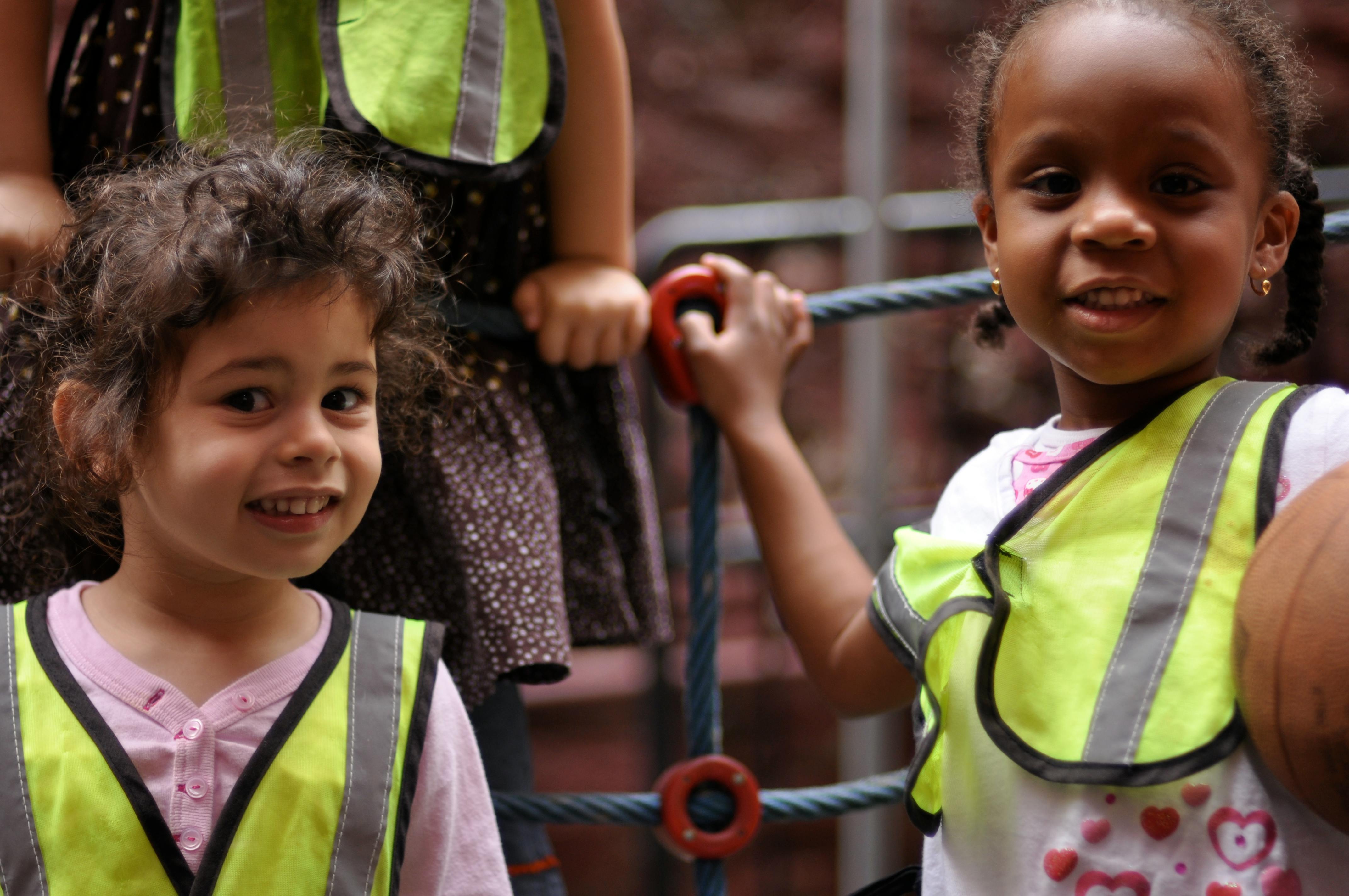 Two children wearing safety vests