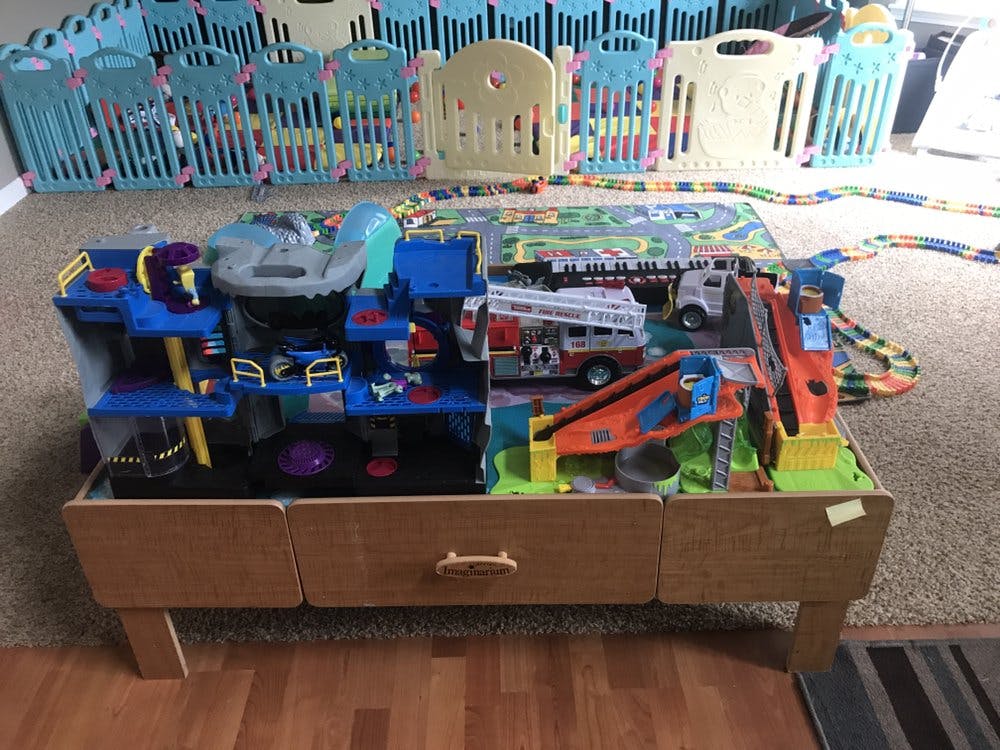 Toy car garage and train set on a wooden table