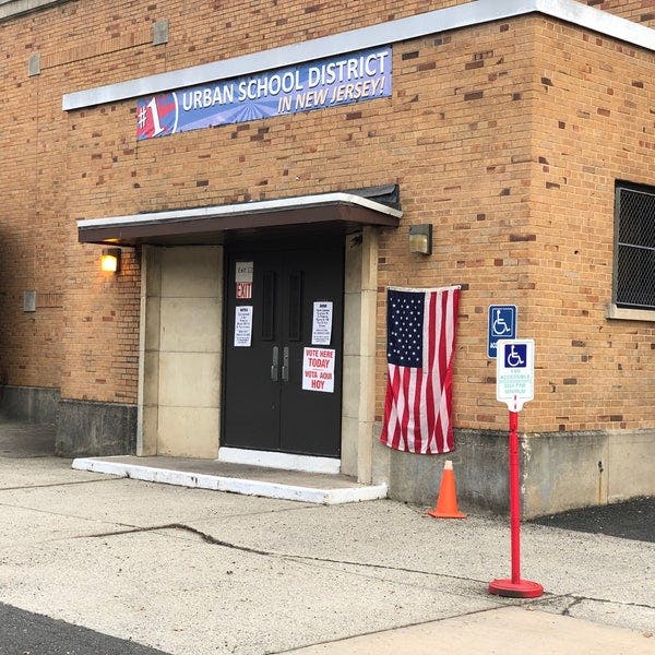 School building entrance with a banner reading "Urban School District"
