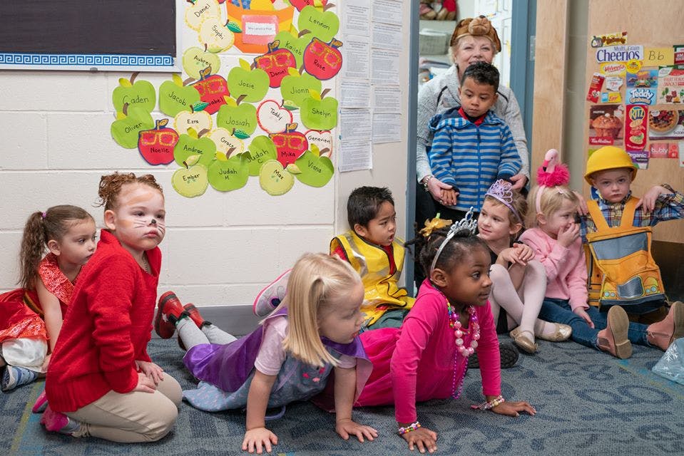 Adult and children in a classroom