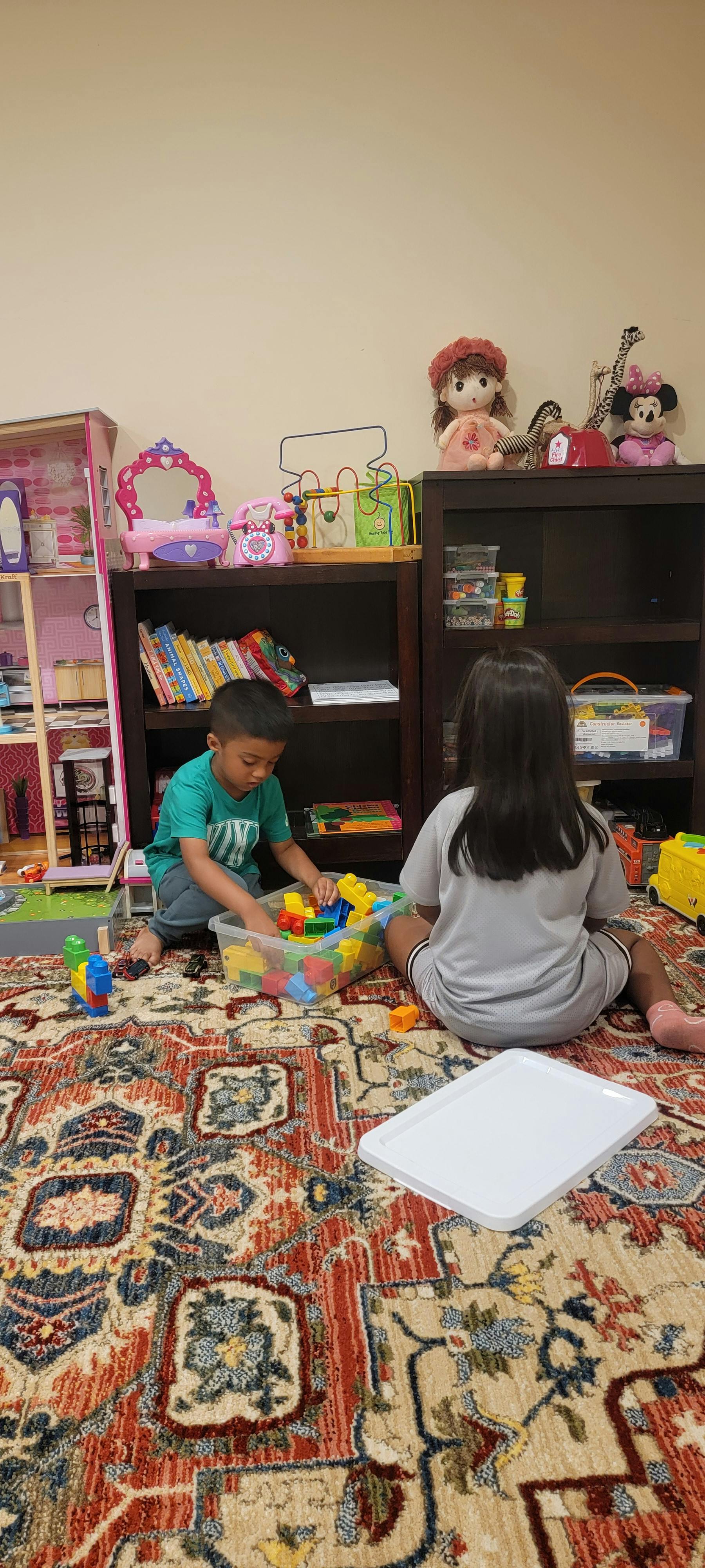 Child playing with building blocks on a rug