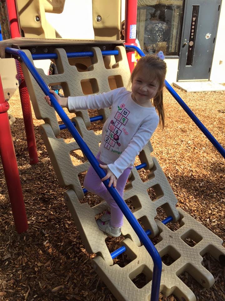 Child climbing on playground equipment