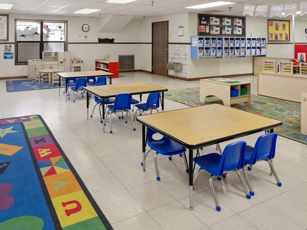 Empty classroom with tables and chairs