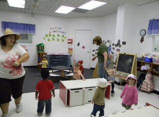 Adults and children in a classroom
