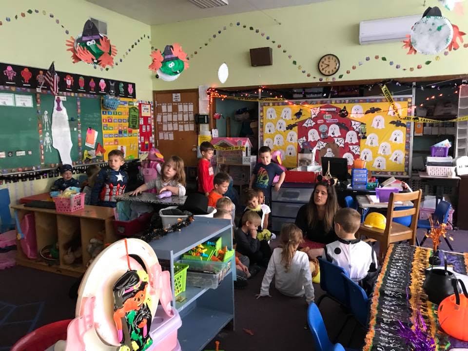 People and children in a classroom