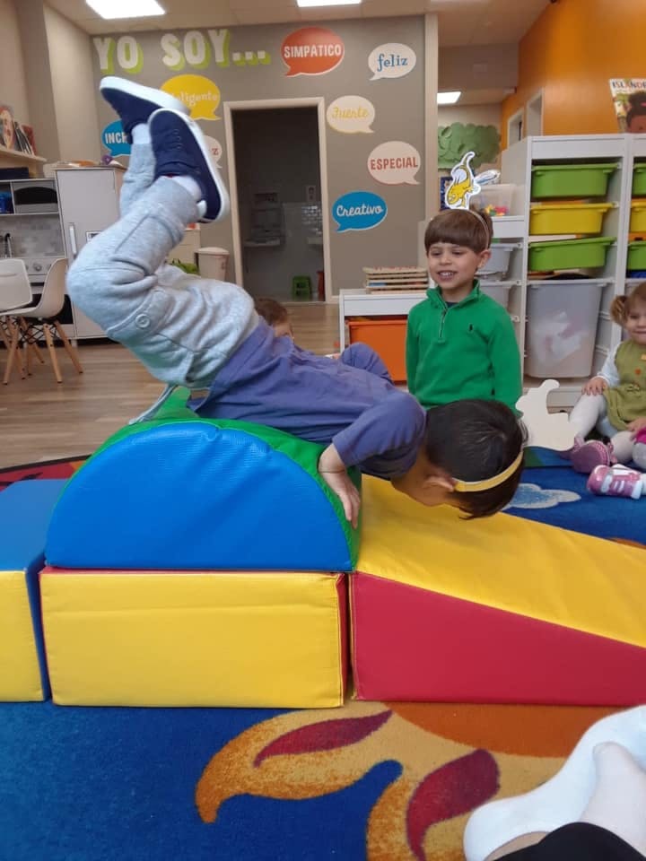 Child playing on soft play equipment in a classroom
