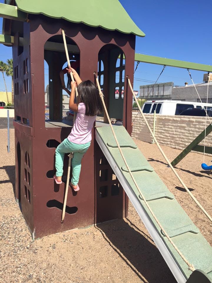 Child climbing a play structure
