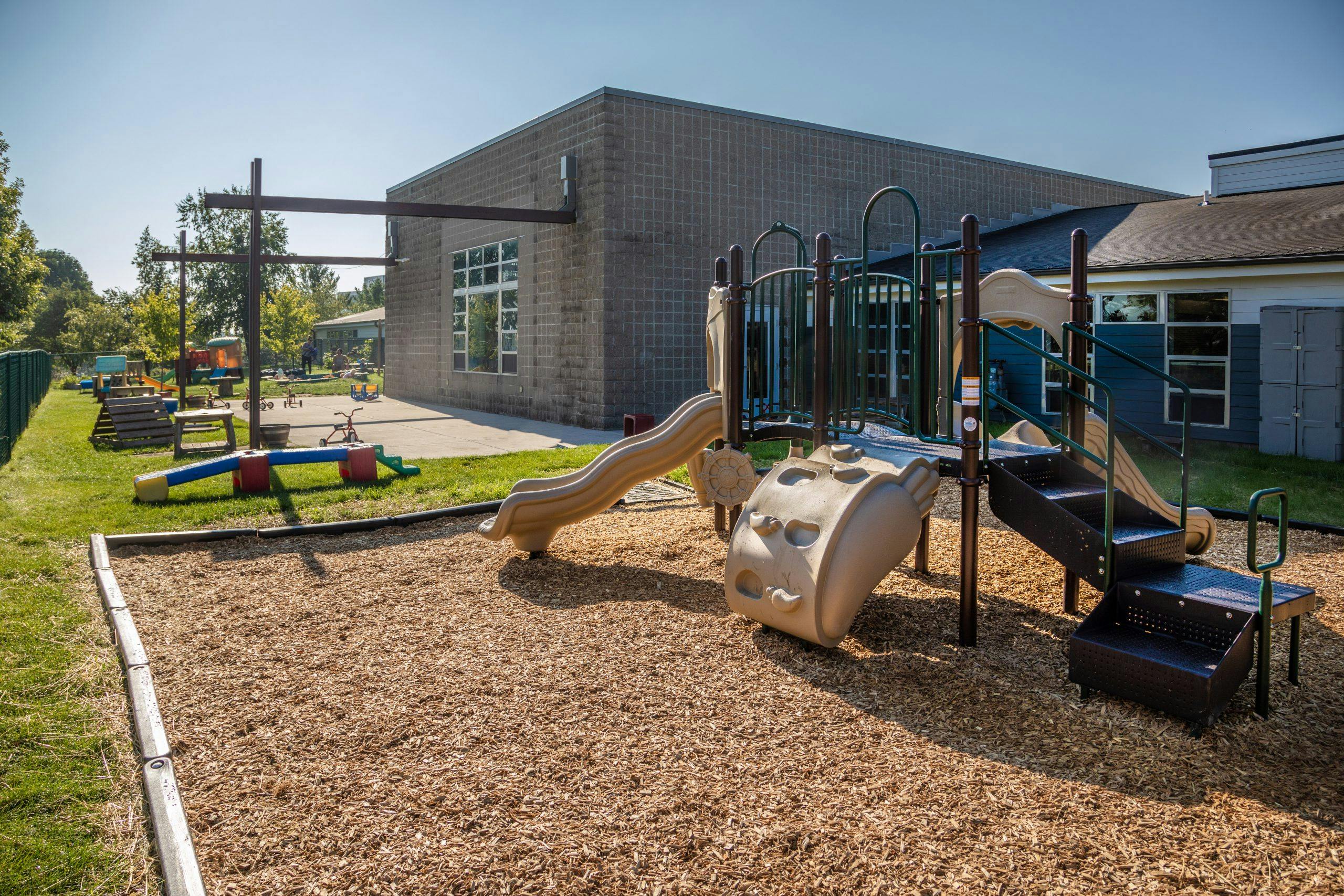 Playground with slides and climbing structures on wood chips