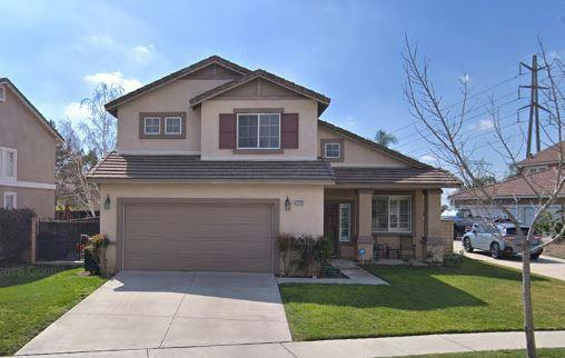 Two-story house with an attached garage and front yard