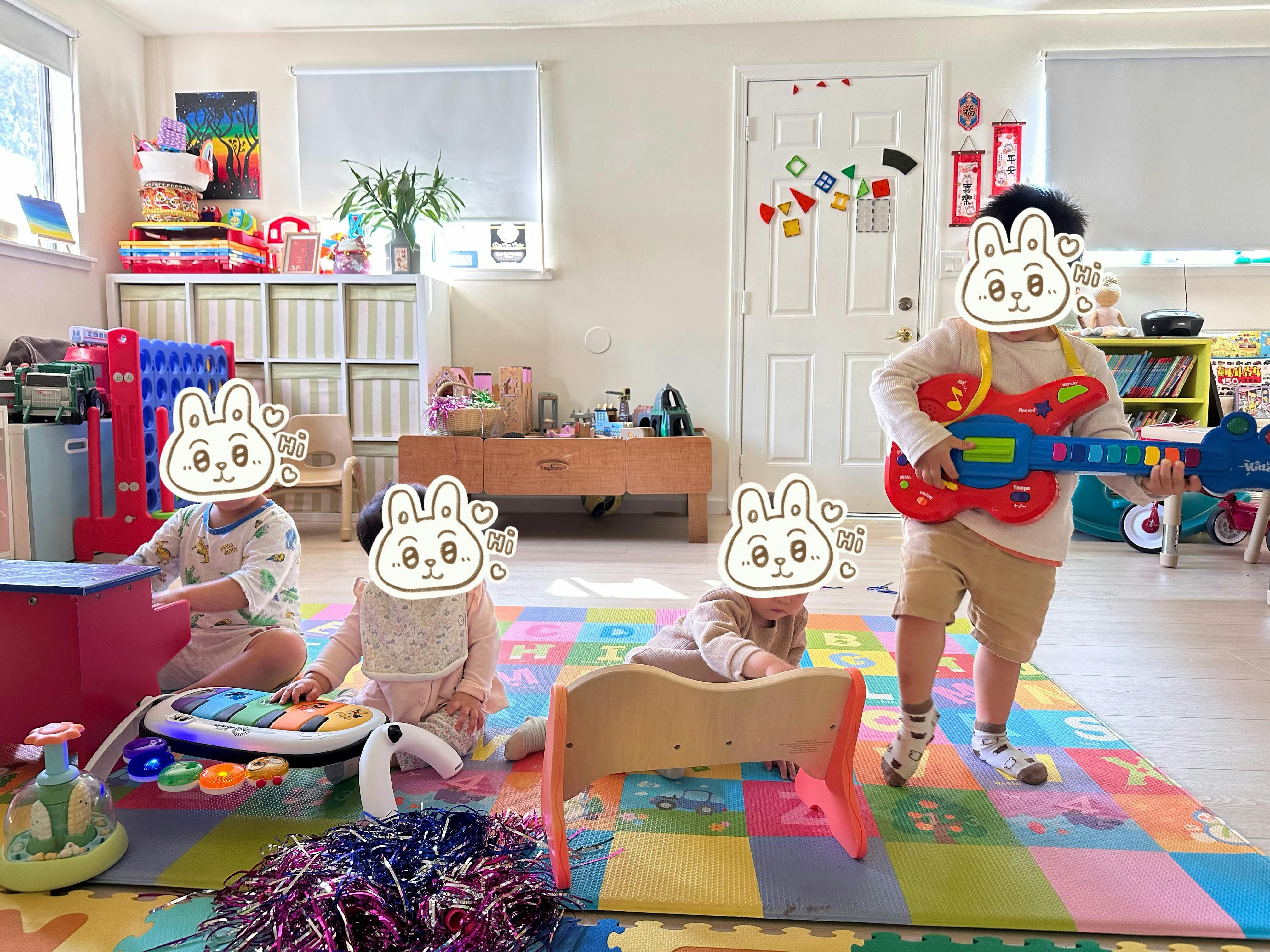 Four children playing with toys on a colorful mat