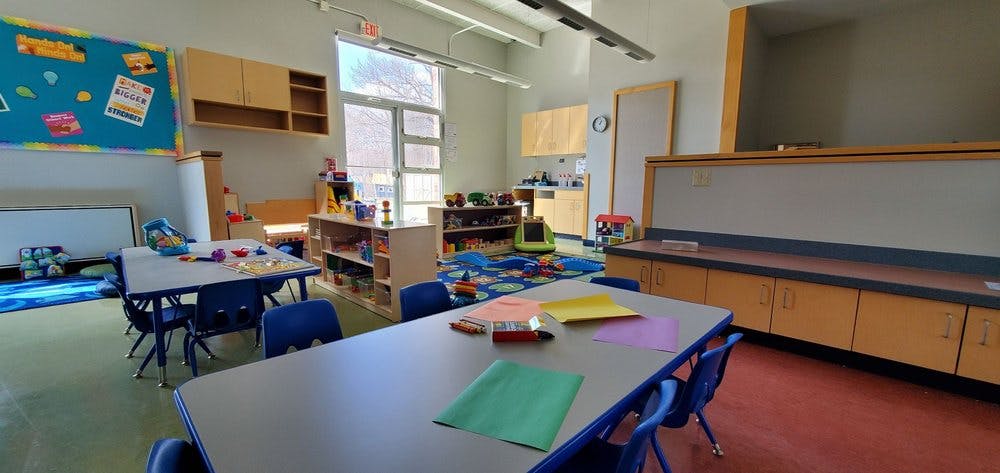 Empty classroom with small tables and chairs