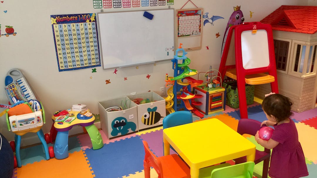Child playing with a ball in a colorful playroom