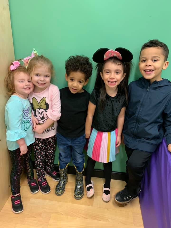 Five children standing together and smiling