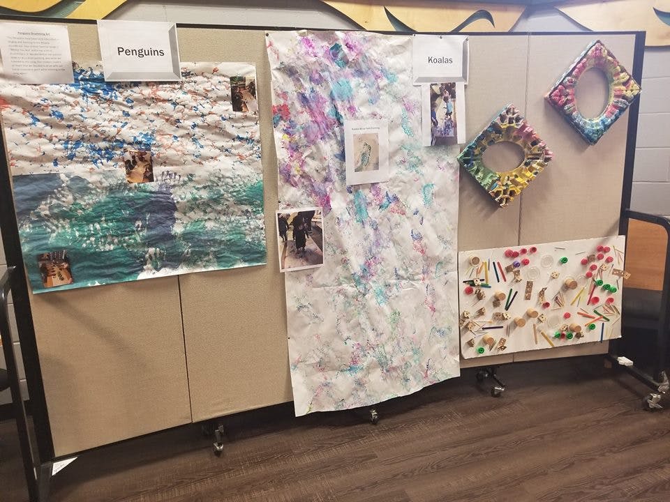 Display board with various children's artwork and crafts