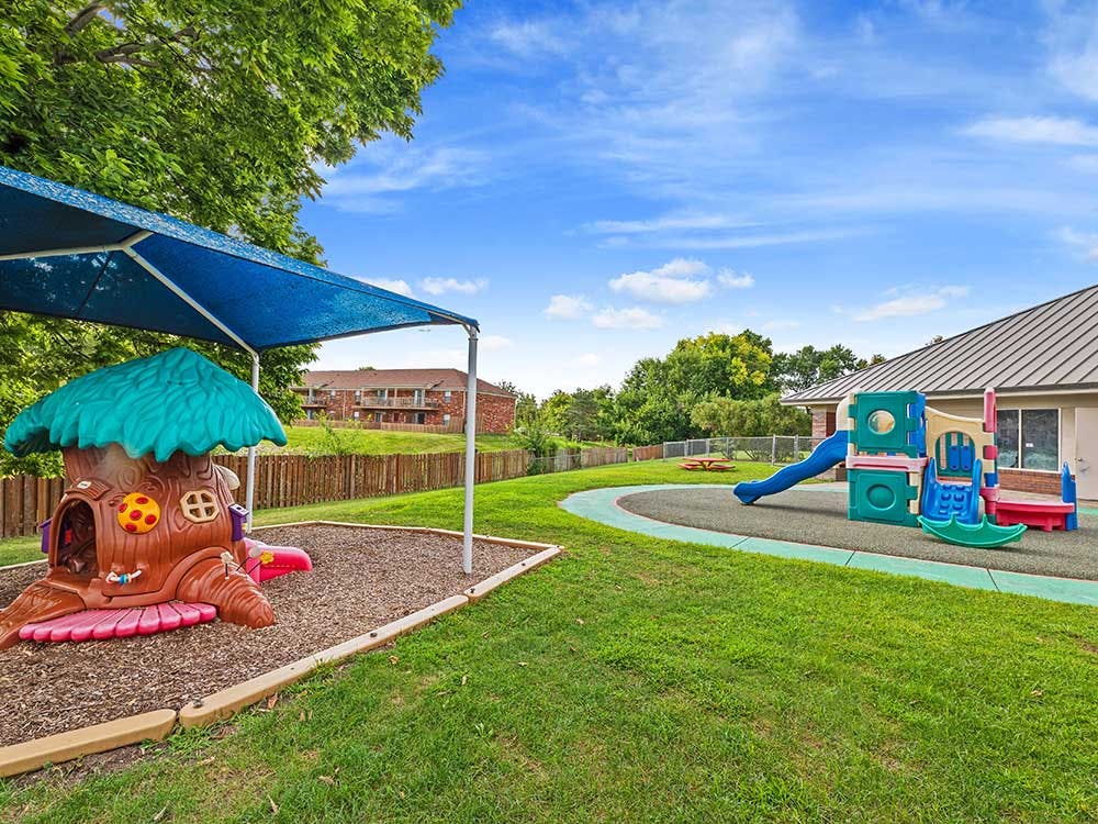 Playground with shaded play structure and slide