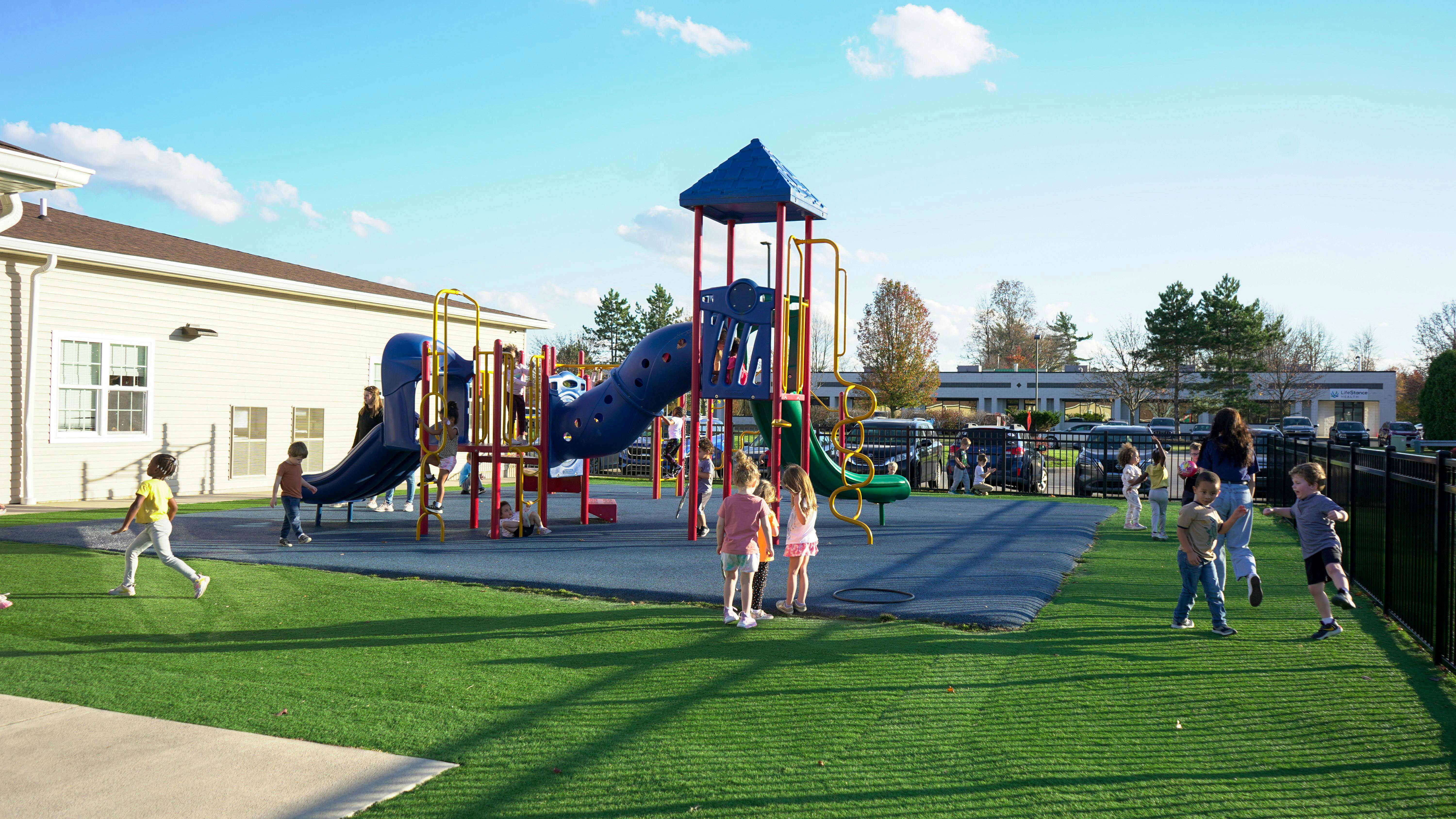 Children playing on a playground with slides and climbing structures