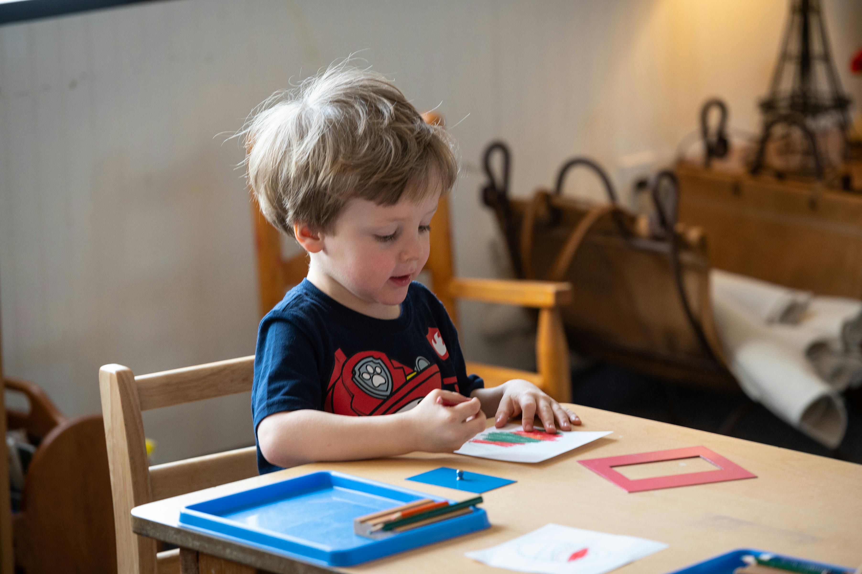 Child drawing at a table