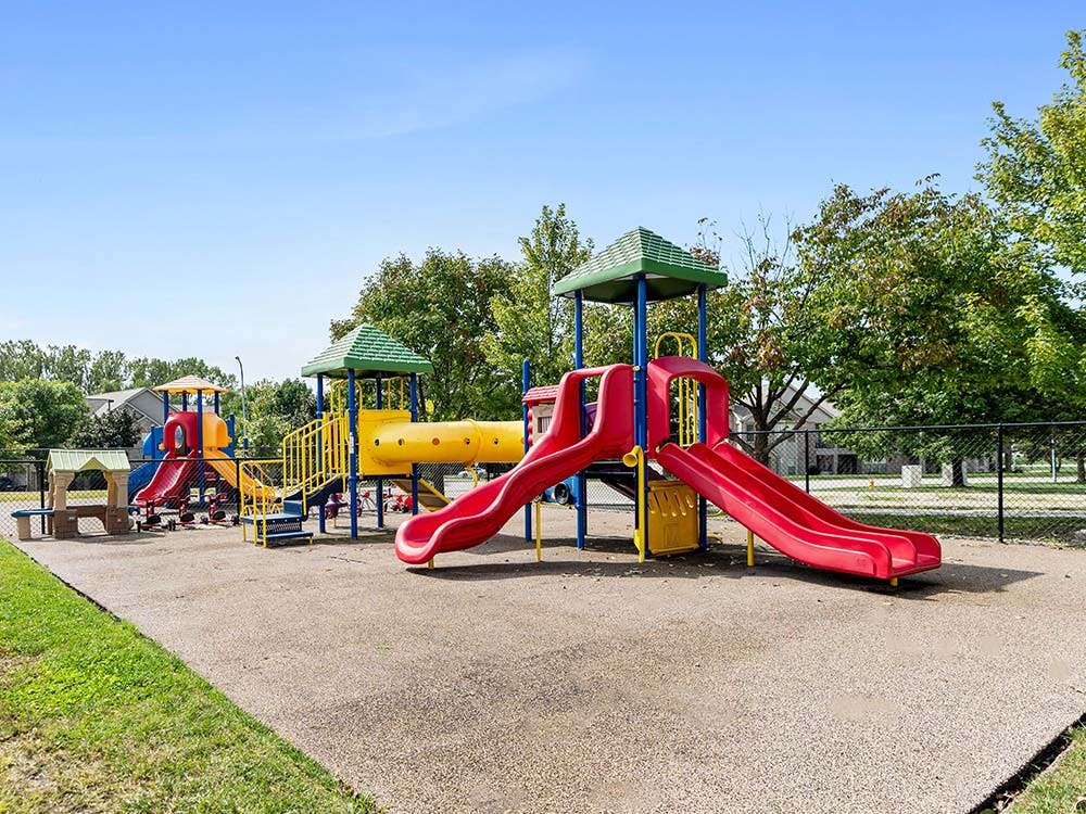 Colorful playground with multiple slides and climbing structures