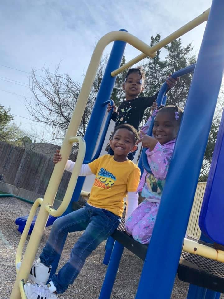 Three children on a playground structure