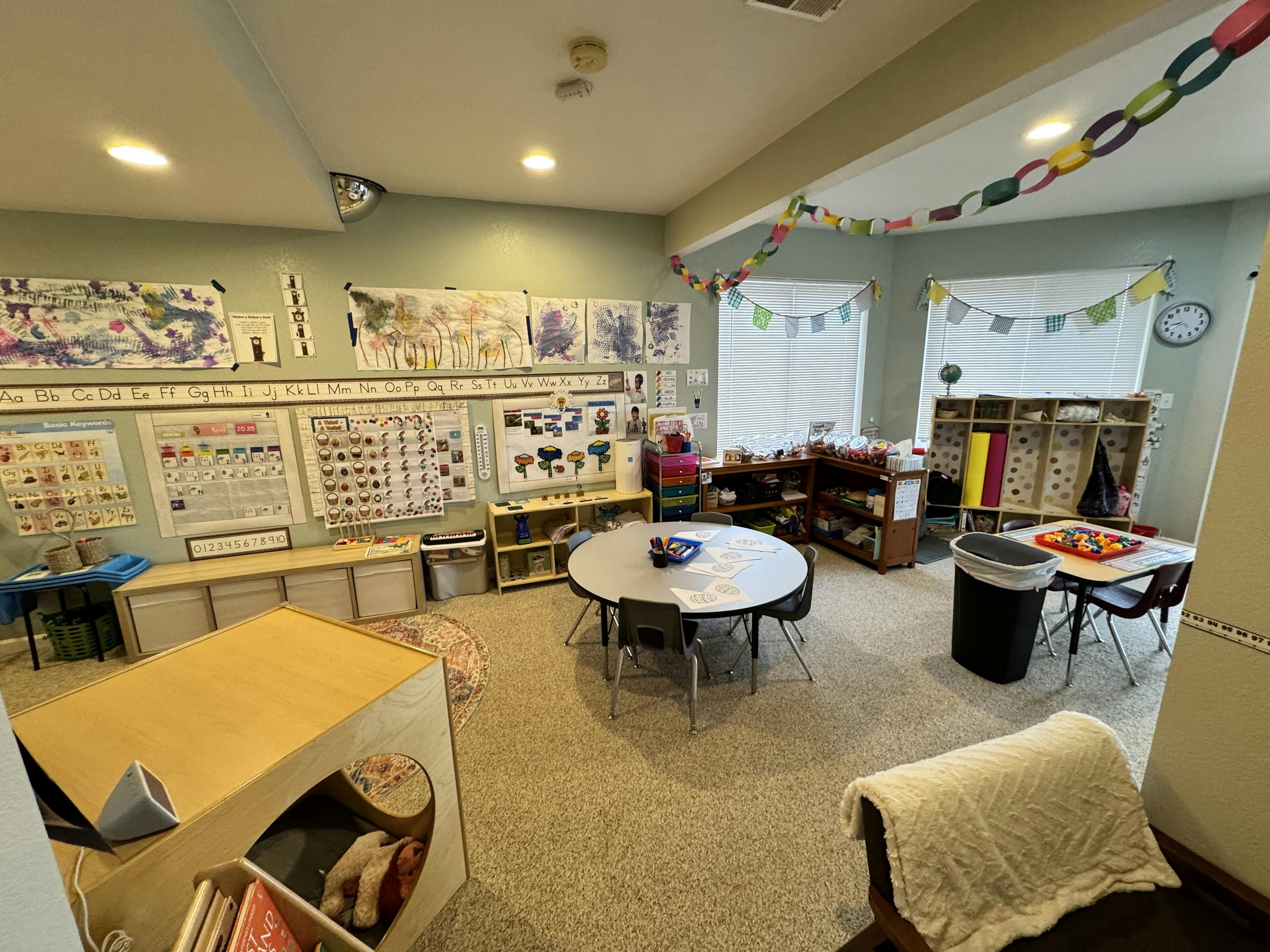 Classroom with tables, chairs, and learning materials
