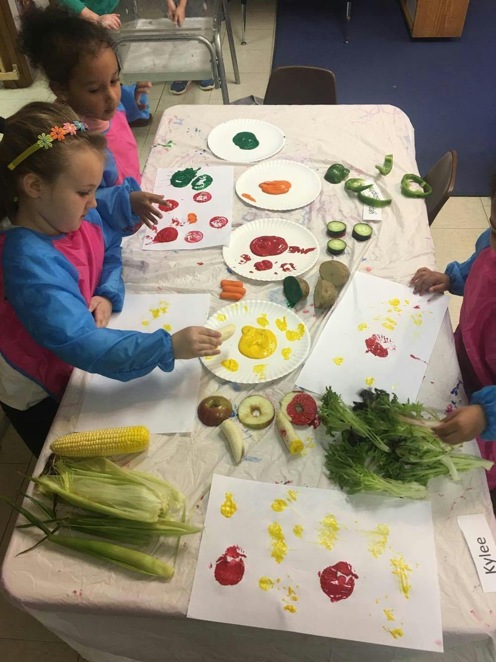 Children making prints with vegetables and paint