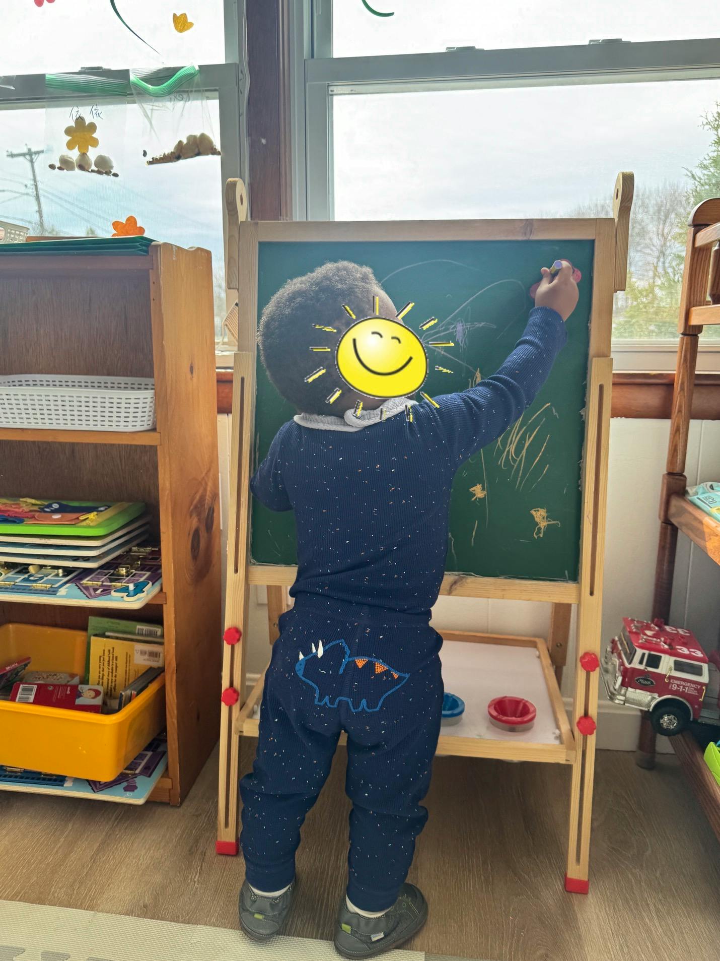 Child drawing on a chalkboard