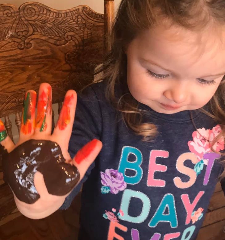 Child with paint on their hand