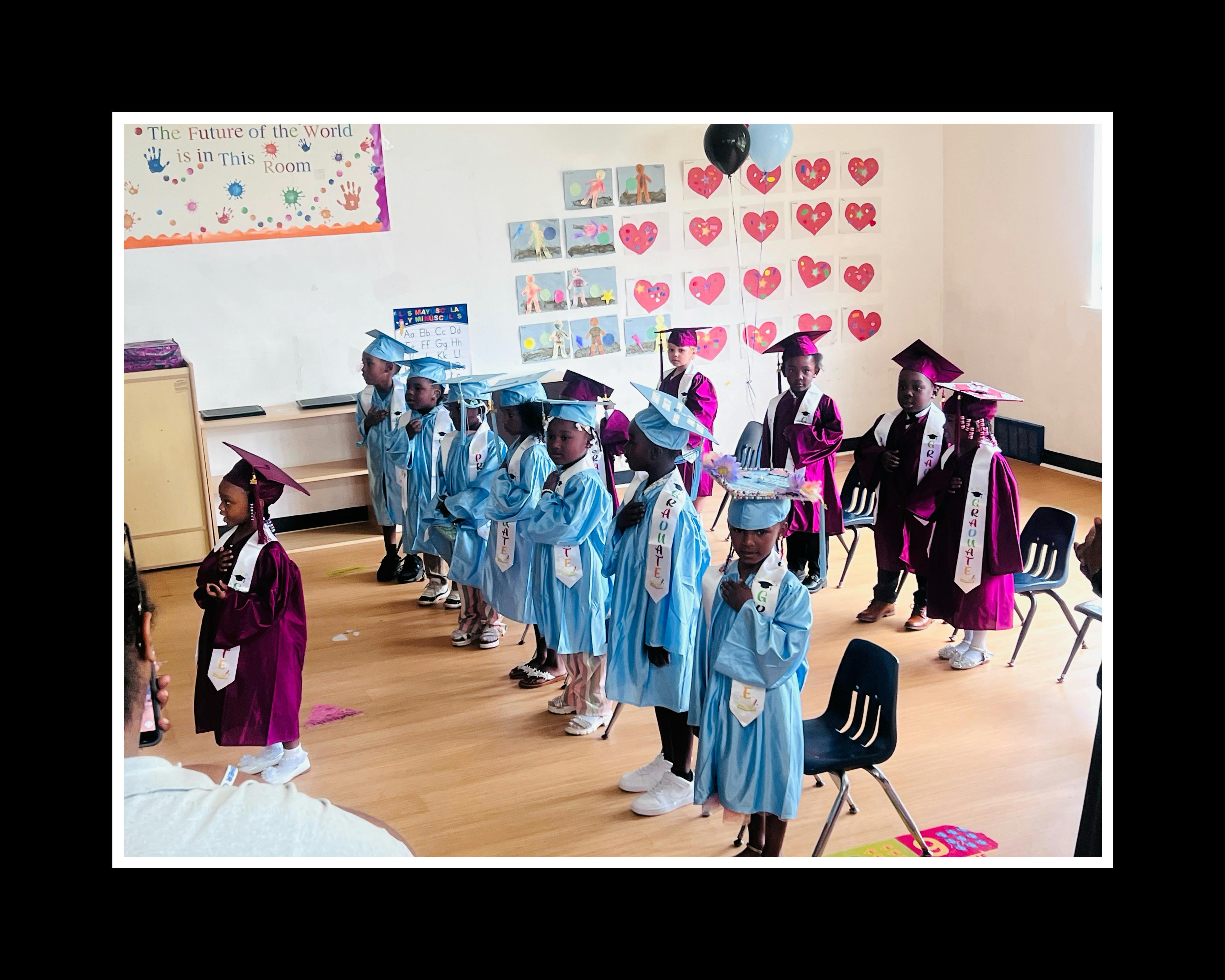 Children in graduation caps and gowns standing in a line