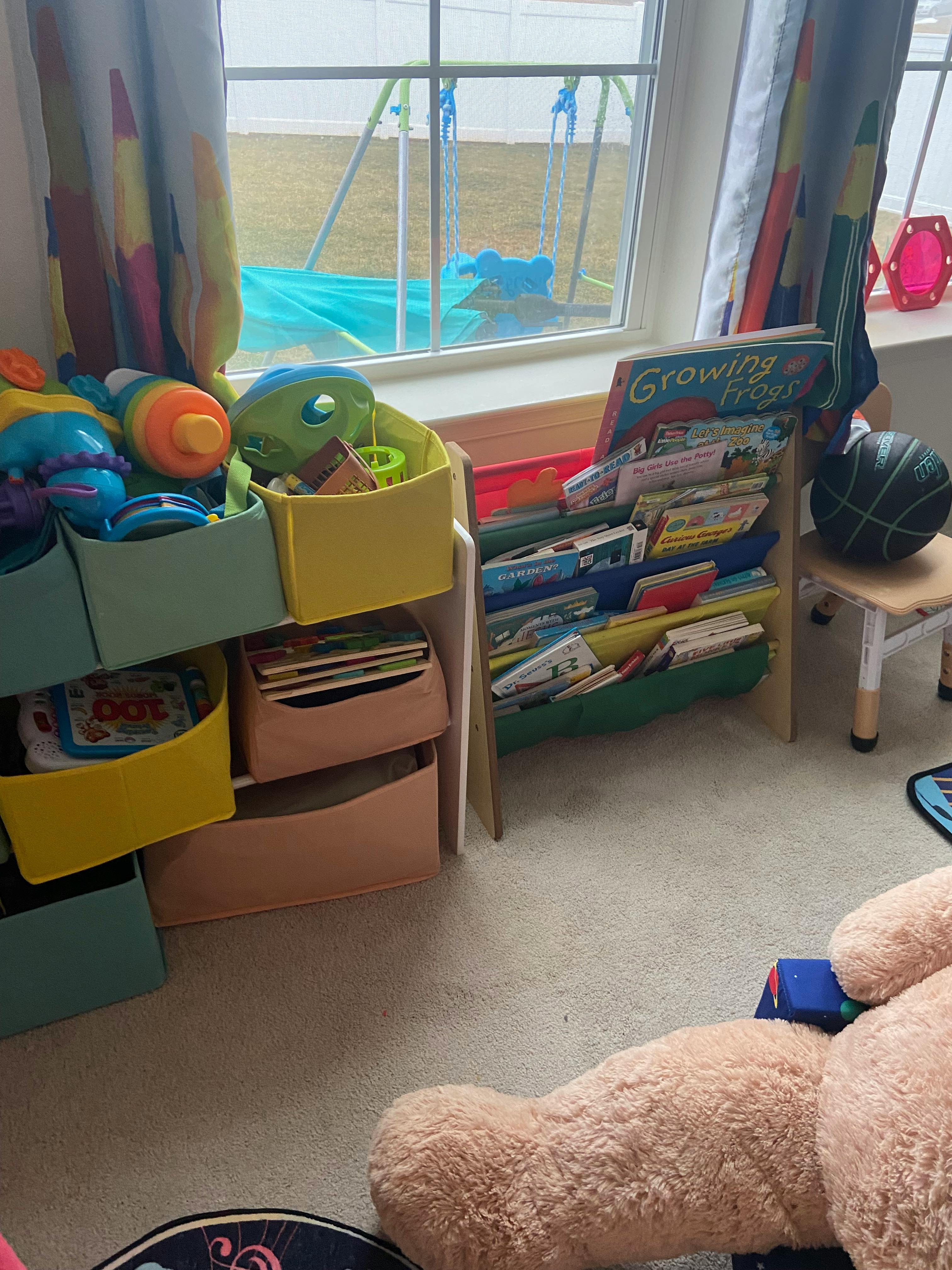 Books and toys in a child's room with a window