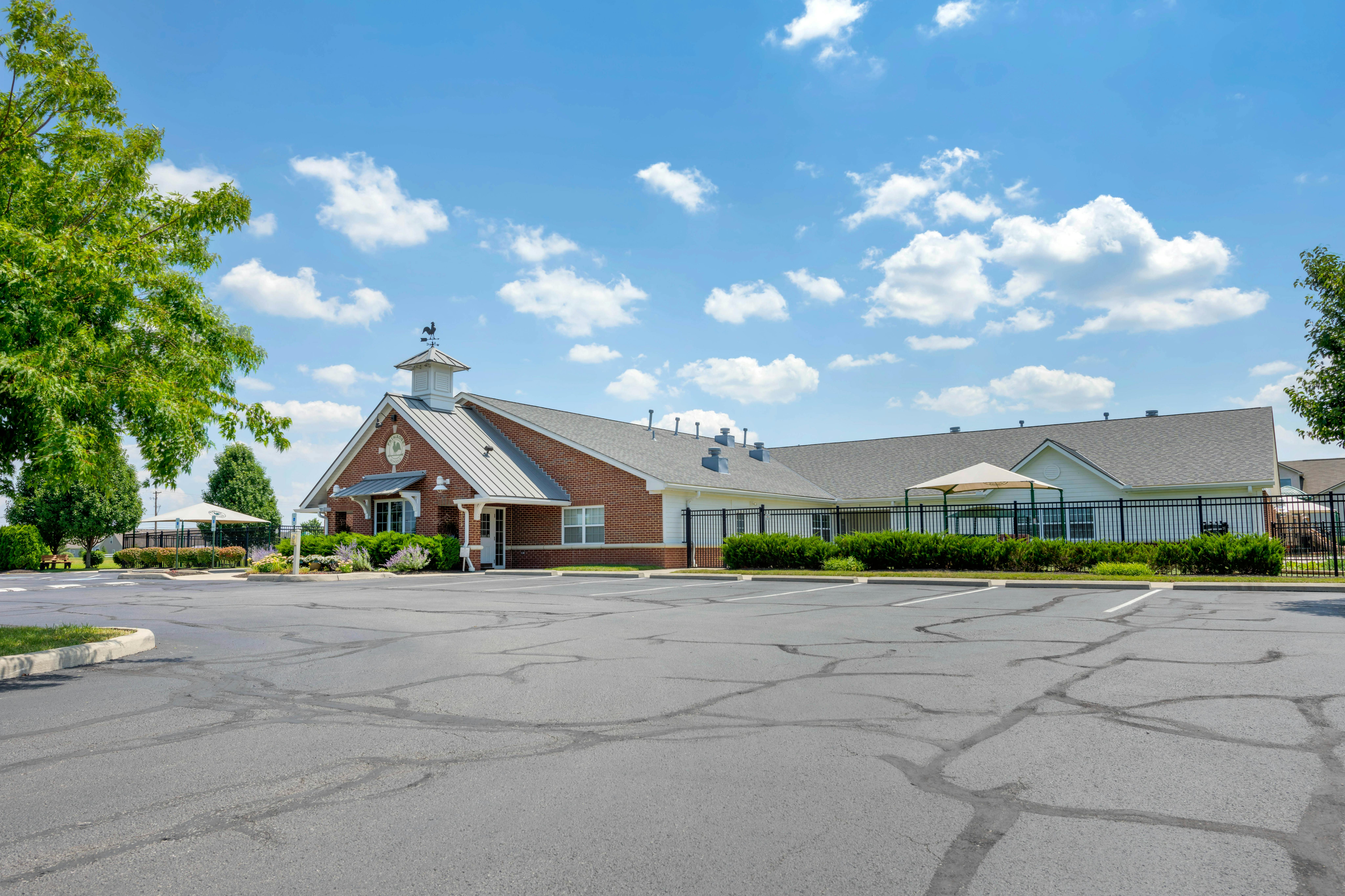 Brick building with a metal roof and a cupola with a weather vane